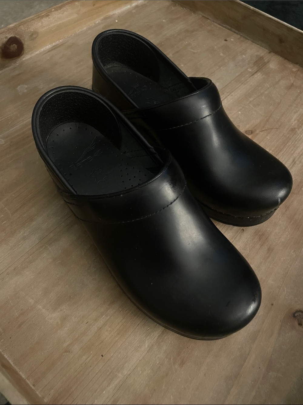 Dansko Black Slip-On Clogs with Stitched Detailing